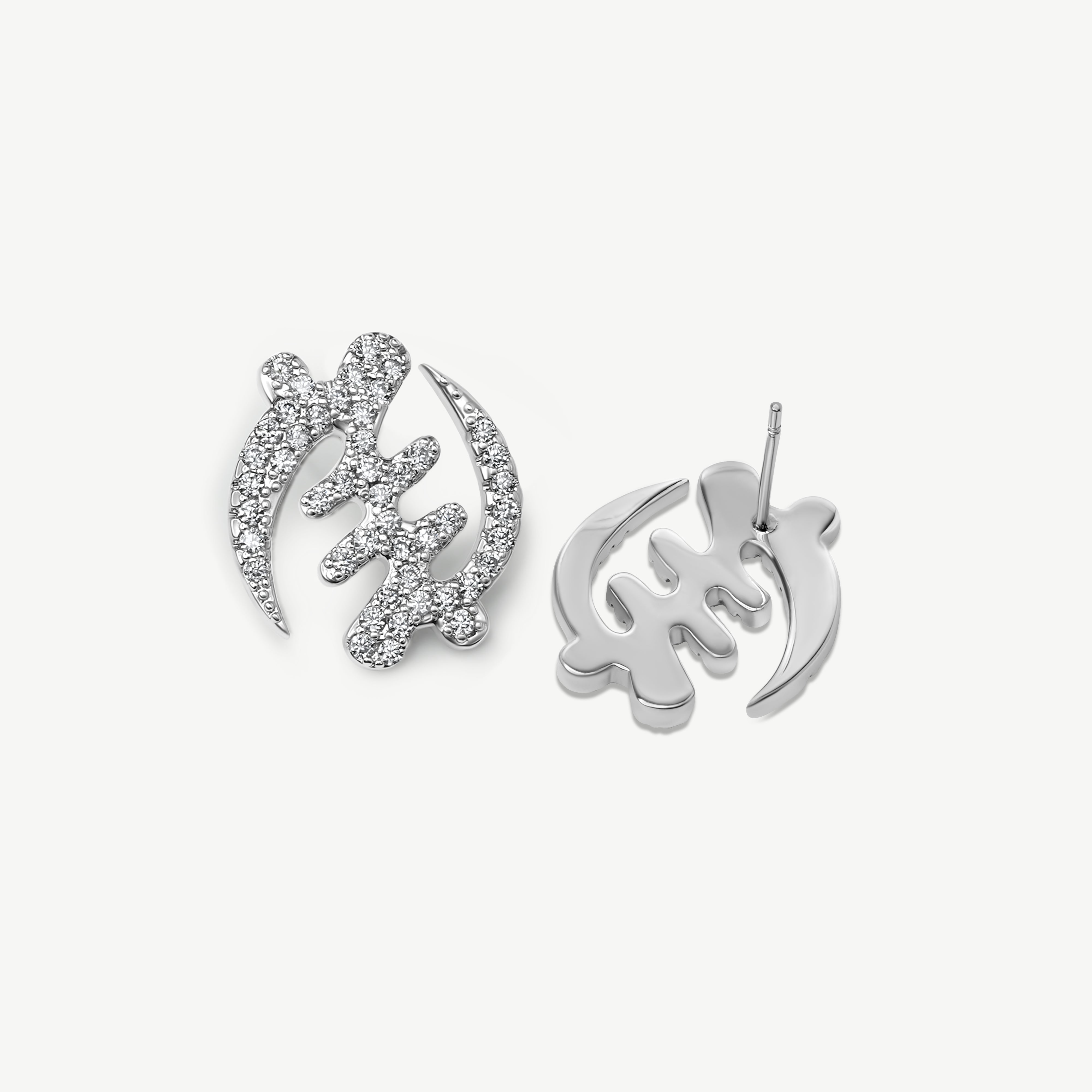 Pair of silver Gye Nyame Adinkra symbol stud earrings, one showing the front with pavé-set high-grade zircon stones and one showing the smooth gold back and post.