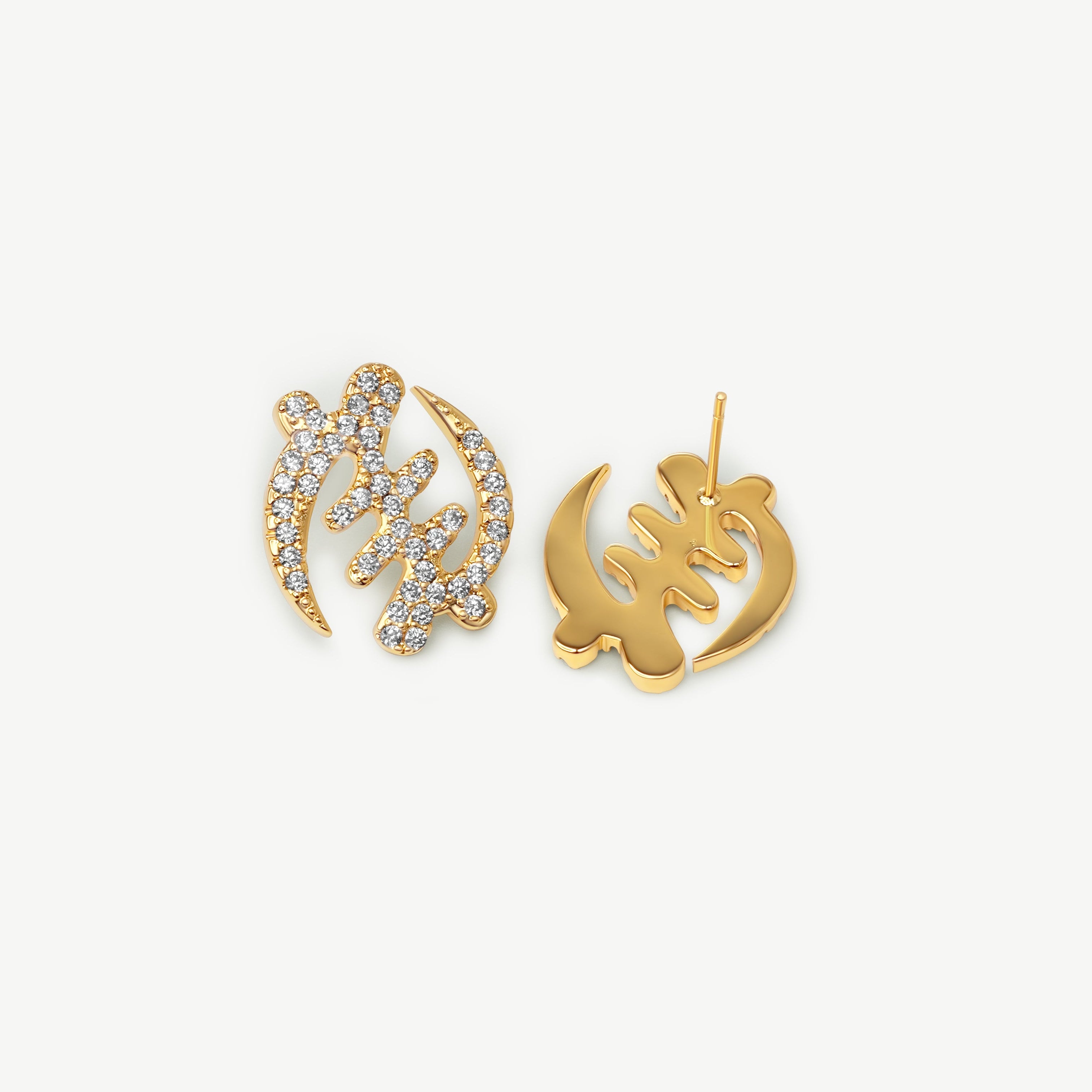 Pair of gold Gye Nyame Adinkra symbol stud earrings, one showing the front with pavé-set high-grade zircon stones and one showing the smooth gold back and post.