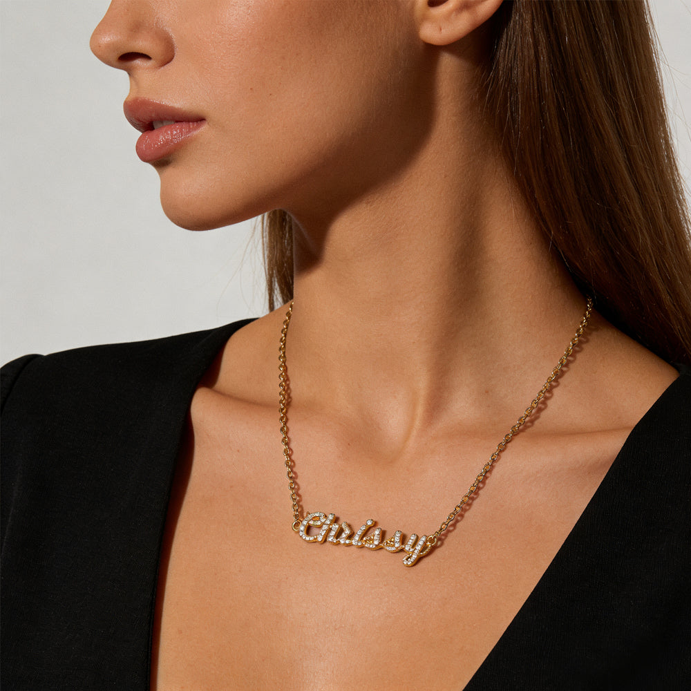 Model wearing the CASA London Custom Pavé Name Necklace in 18ct gold vermeil on S925 sterling silver, styled as a layering piece