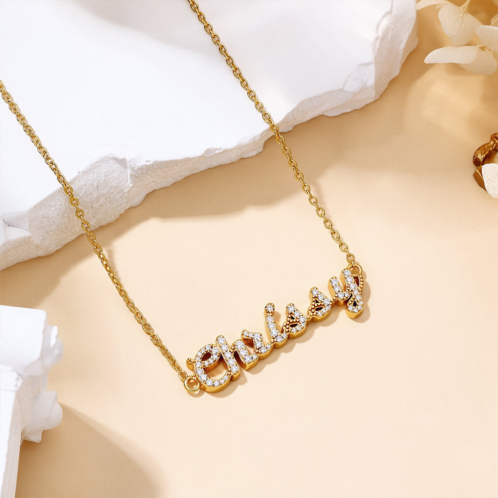 Close-up of model wearing the CASA London Custom Pavé Name Necklace in 18ct gold vermeil on S925 sterling silver, showcasing hand-set moissanite detailing