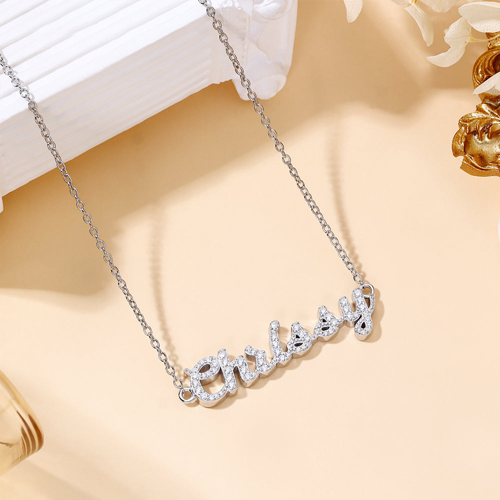 CASA London Custom Pavé Name Necklace in rhodium silver on S925 sterling silver, featuring hand-set moissanite stones on a cable chain — product flat lay