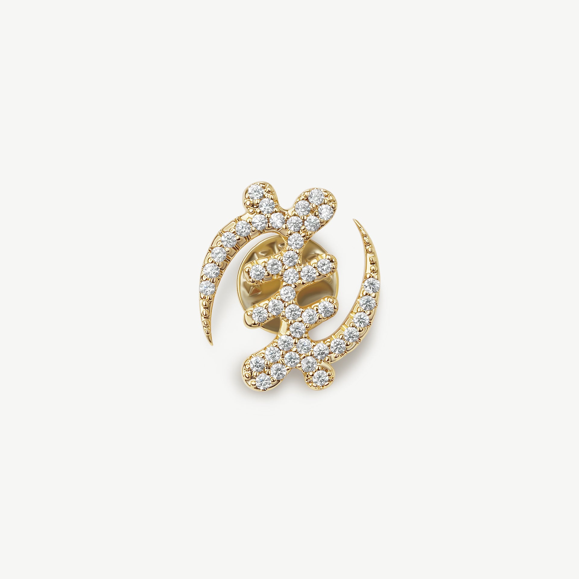 A product shot of CASA London's 18k gold plated Gye Nyame lapel pin. The pin is meticulously shaped into the iconic Adinkra symbol and encrusted with shimmering pavé-set stones. This display highlights the brand's commitment to superior craftsmanship and the fusion of cultural heritage with modern luxury.
