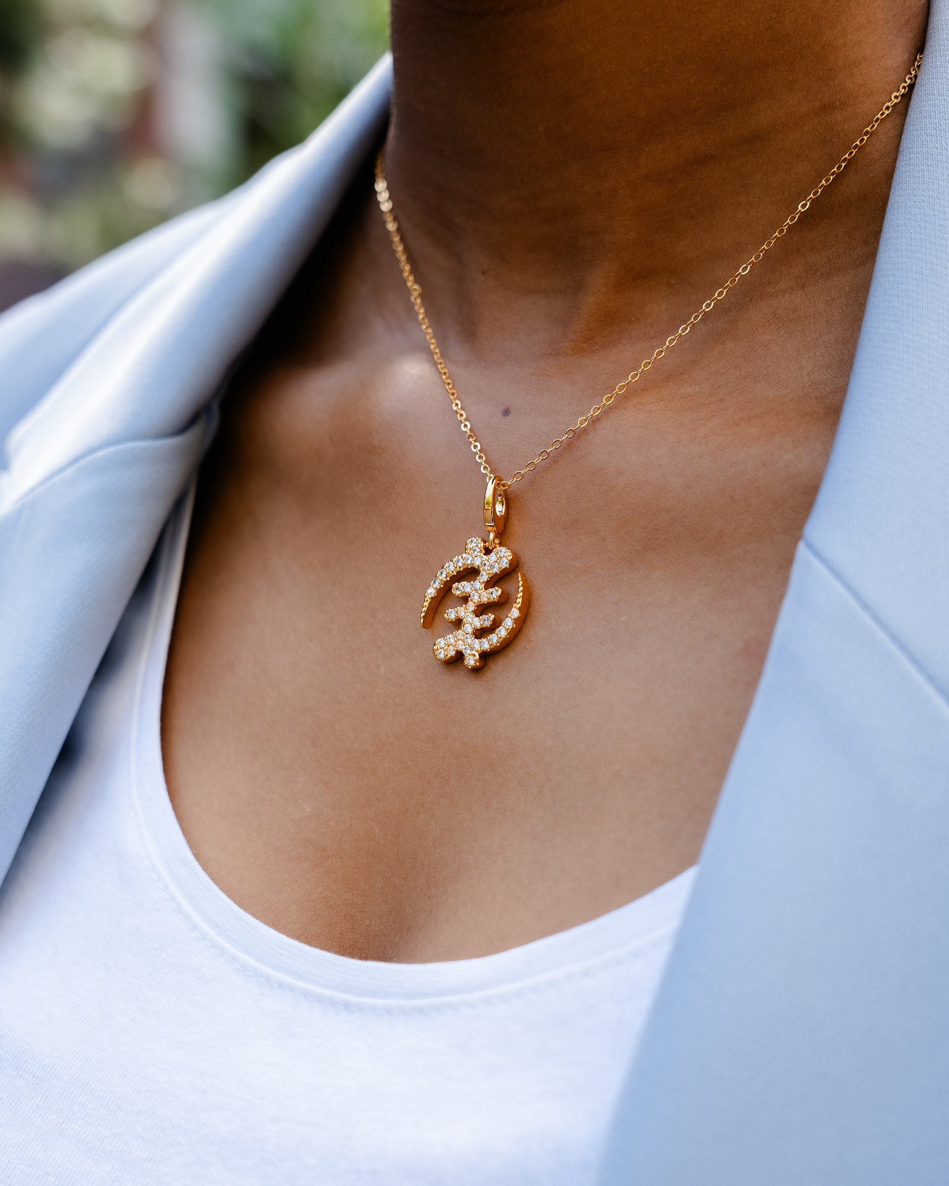CASA LONDON Gye Nyame Pendant in 18ct gold plated — Symbolizing the 'Supremacy of God', this pendant also adds cultural significance to your look, versatile and timeless, pair it with a chain or bracelet for a complete look.